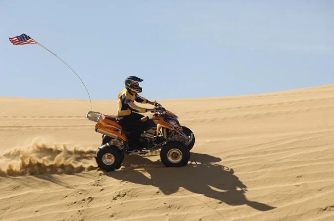 An exhilarating desert adventure, filled with activities like dune bashing, quad biking, camel rides